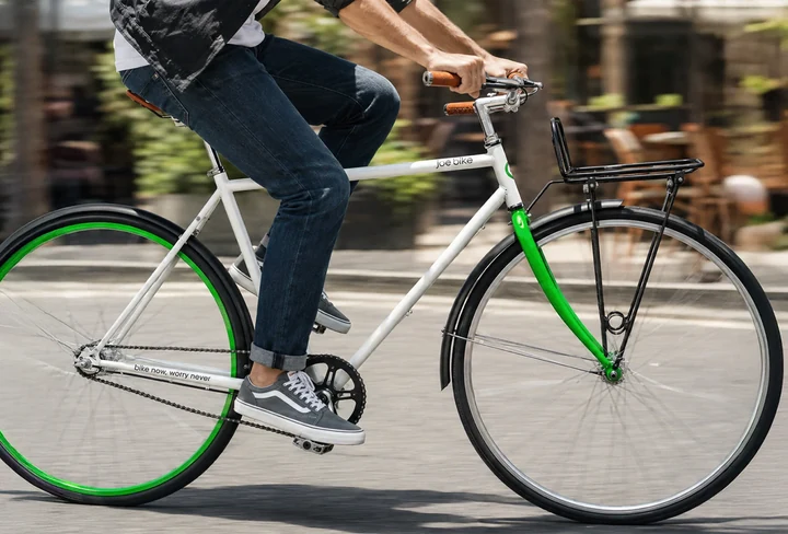Student riding a Joe Bike through the city.