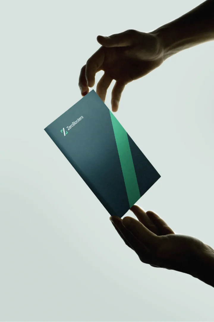 ZeroBlockers business card held between two hands.