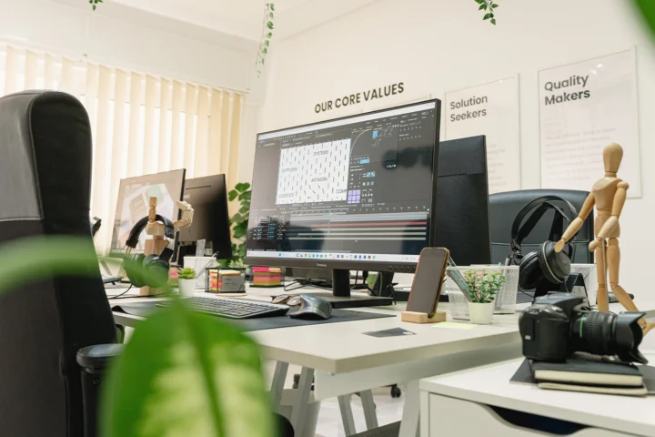 Brandegree studio workspace with design screens and a wooden mannequin