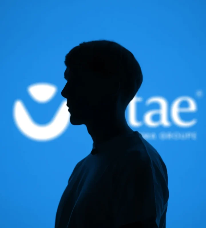 Vitae identity at an event with a speaker in silhouette.